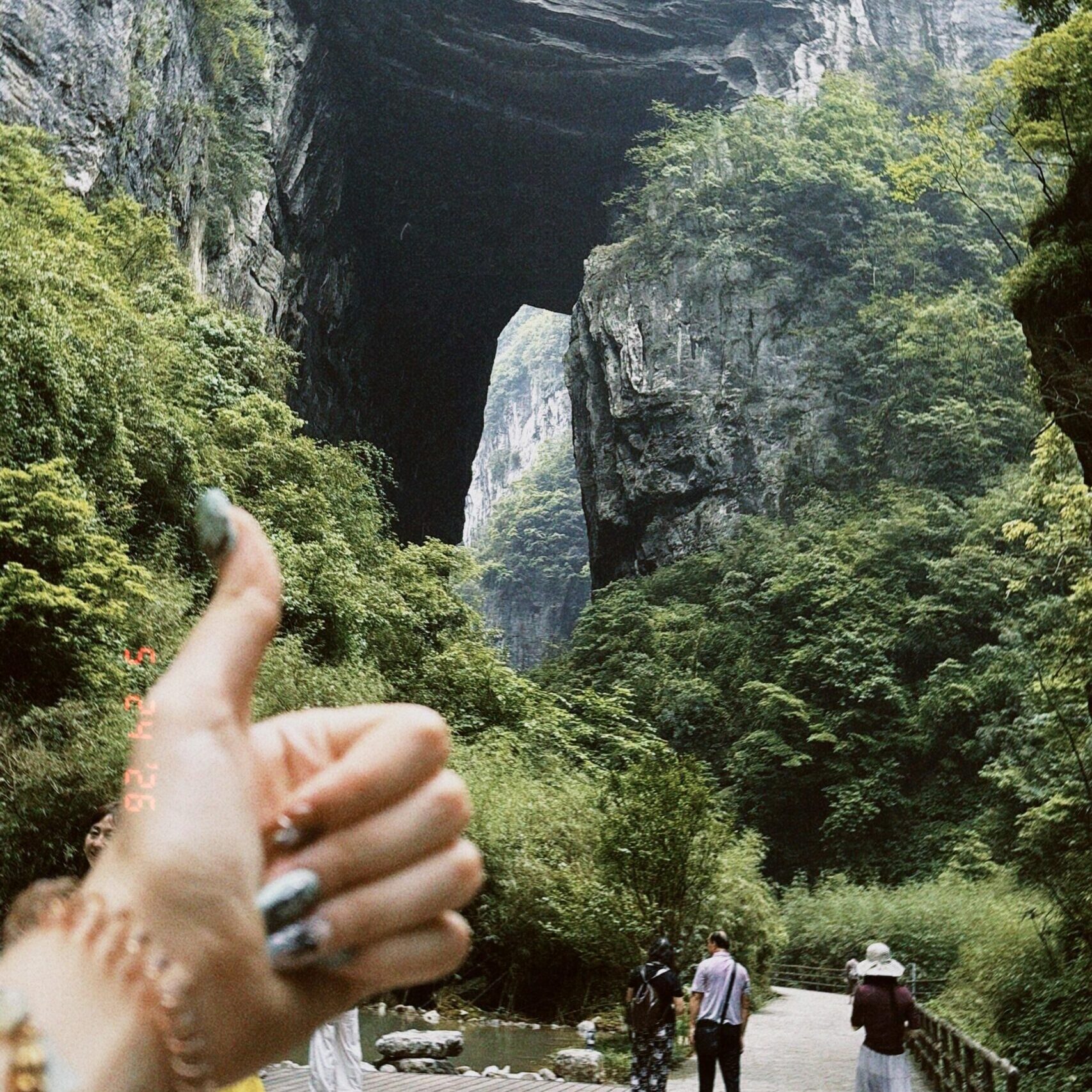 Visitors exploring the waterfalls and canyon scenery during a Wulong day tour from Chongqing