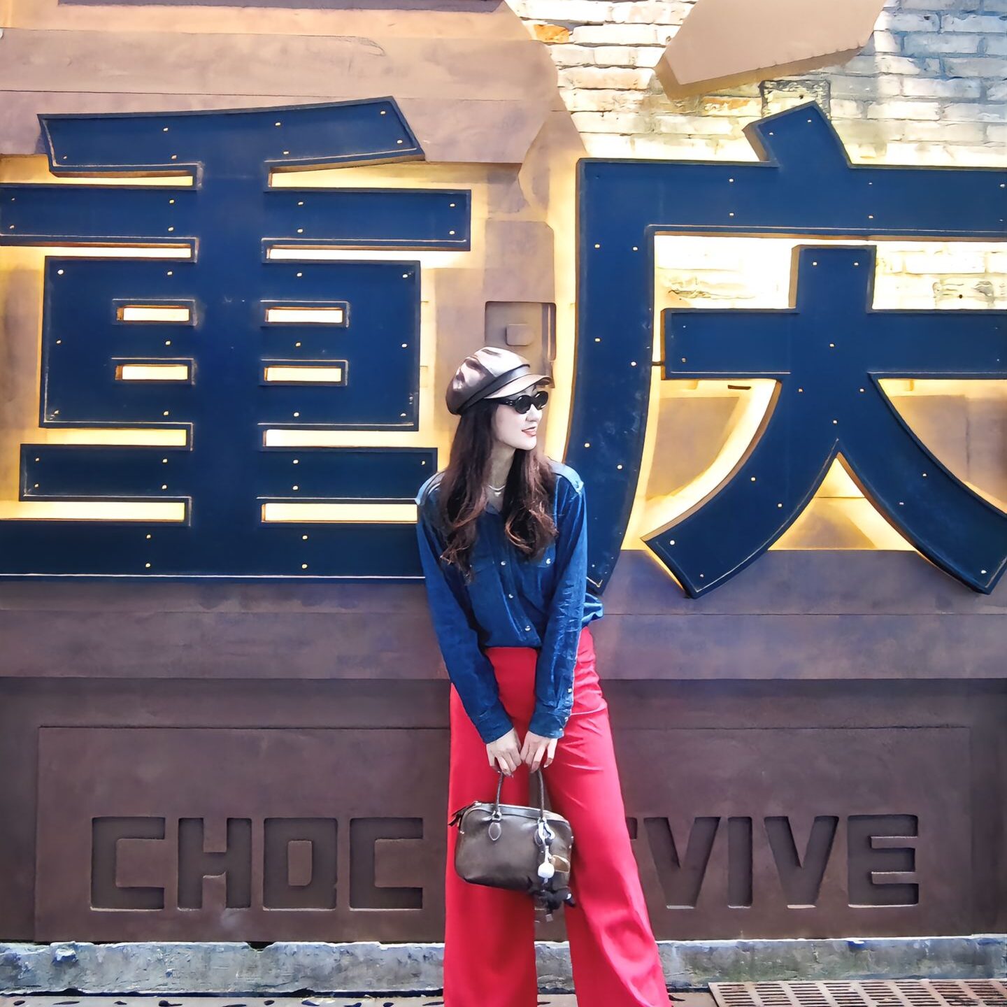 Tourist posing with Chongqing city landmark sign during a private tour