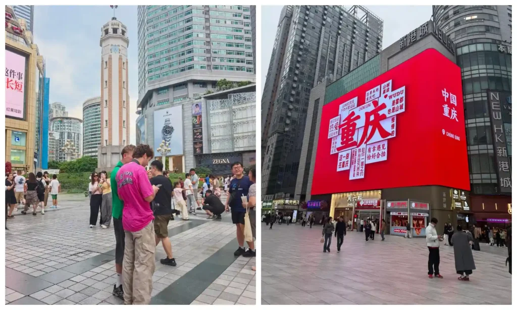 Visitors walking through a busy Chongqing shopping street with a large red display